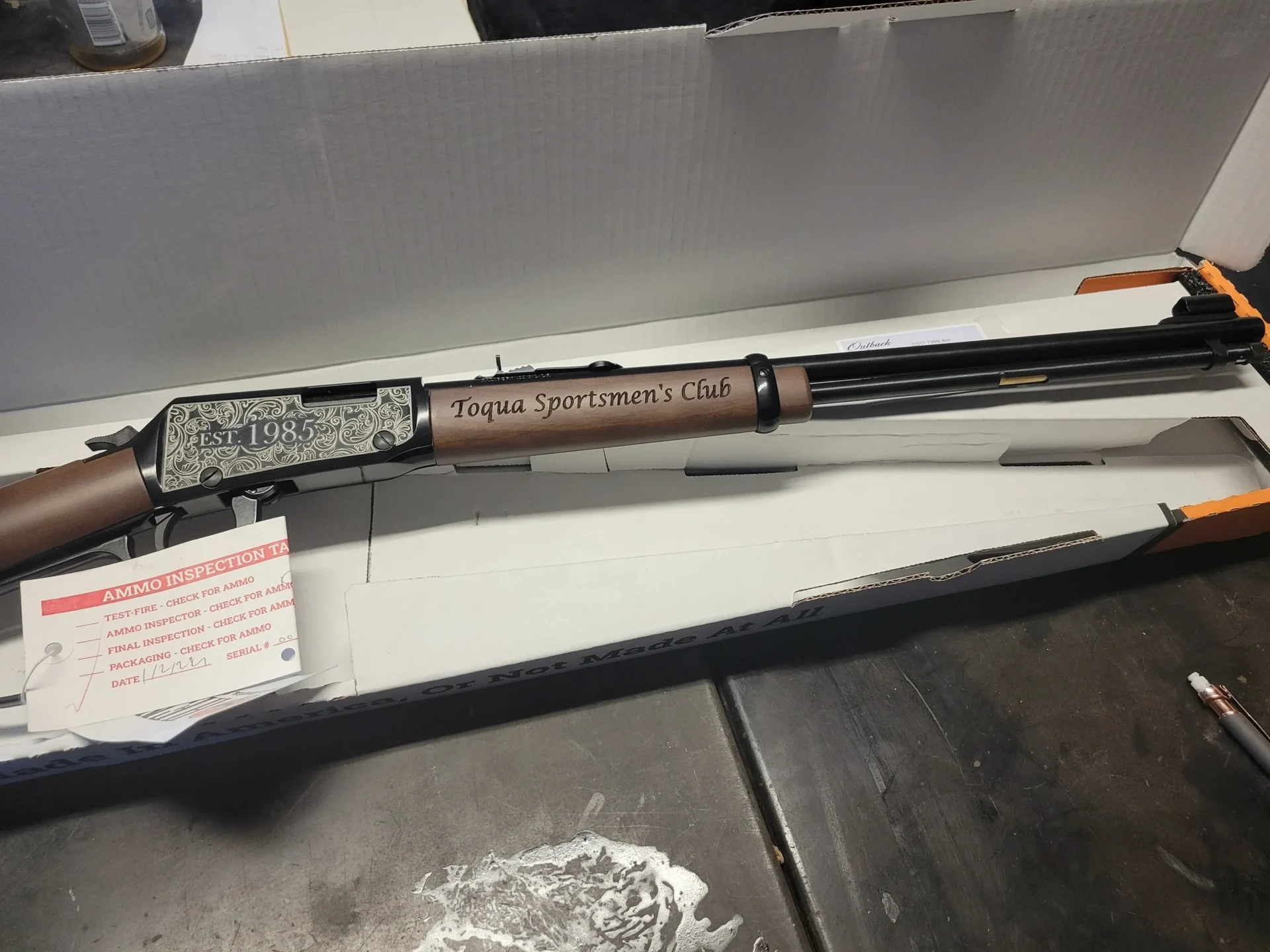 Decorative rifle in open box on table.