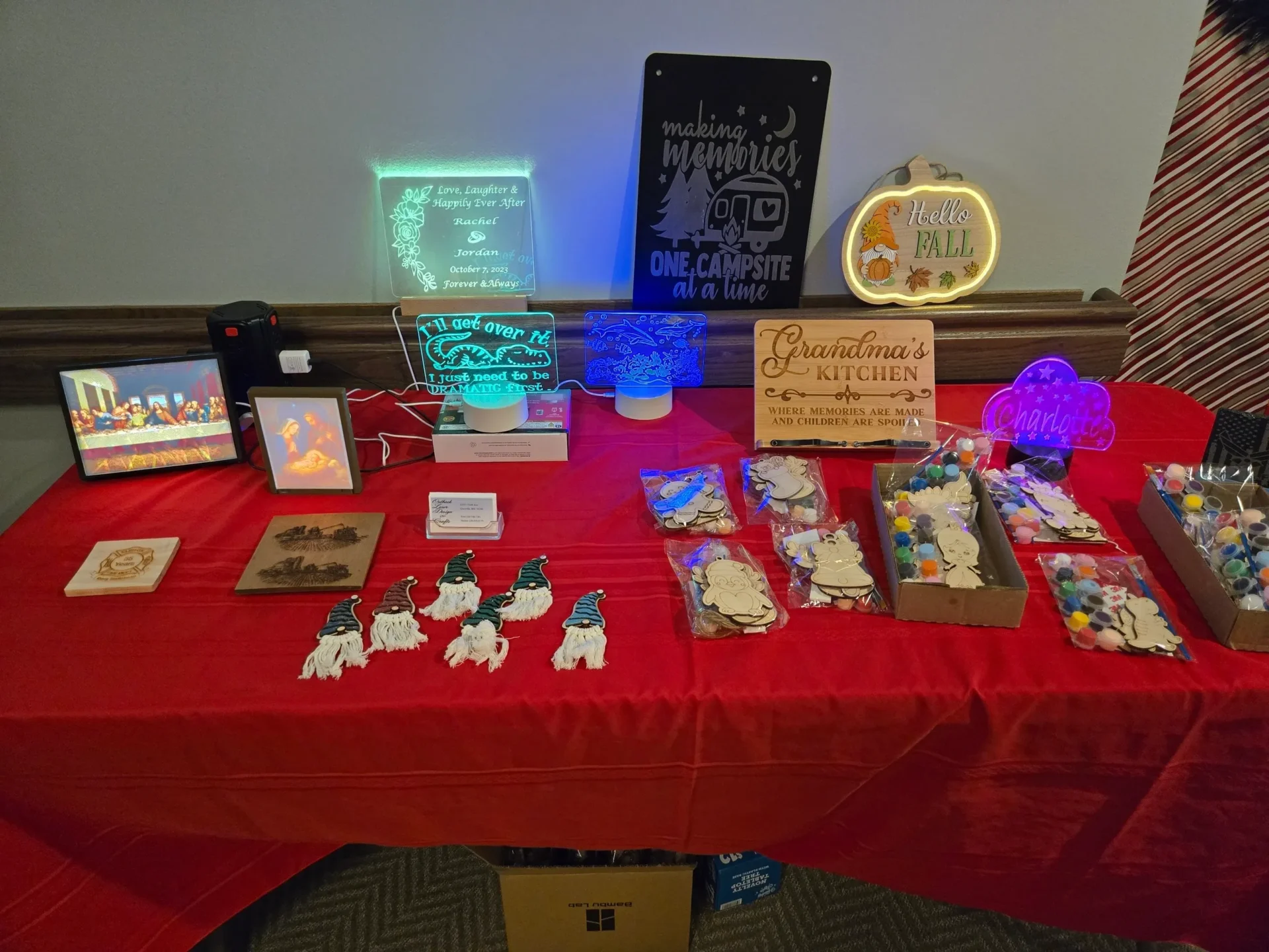 Craft items displayed on a red table.