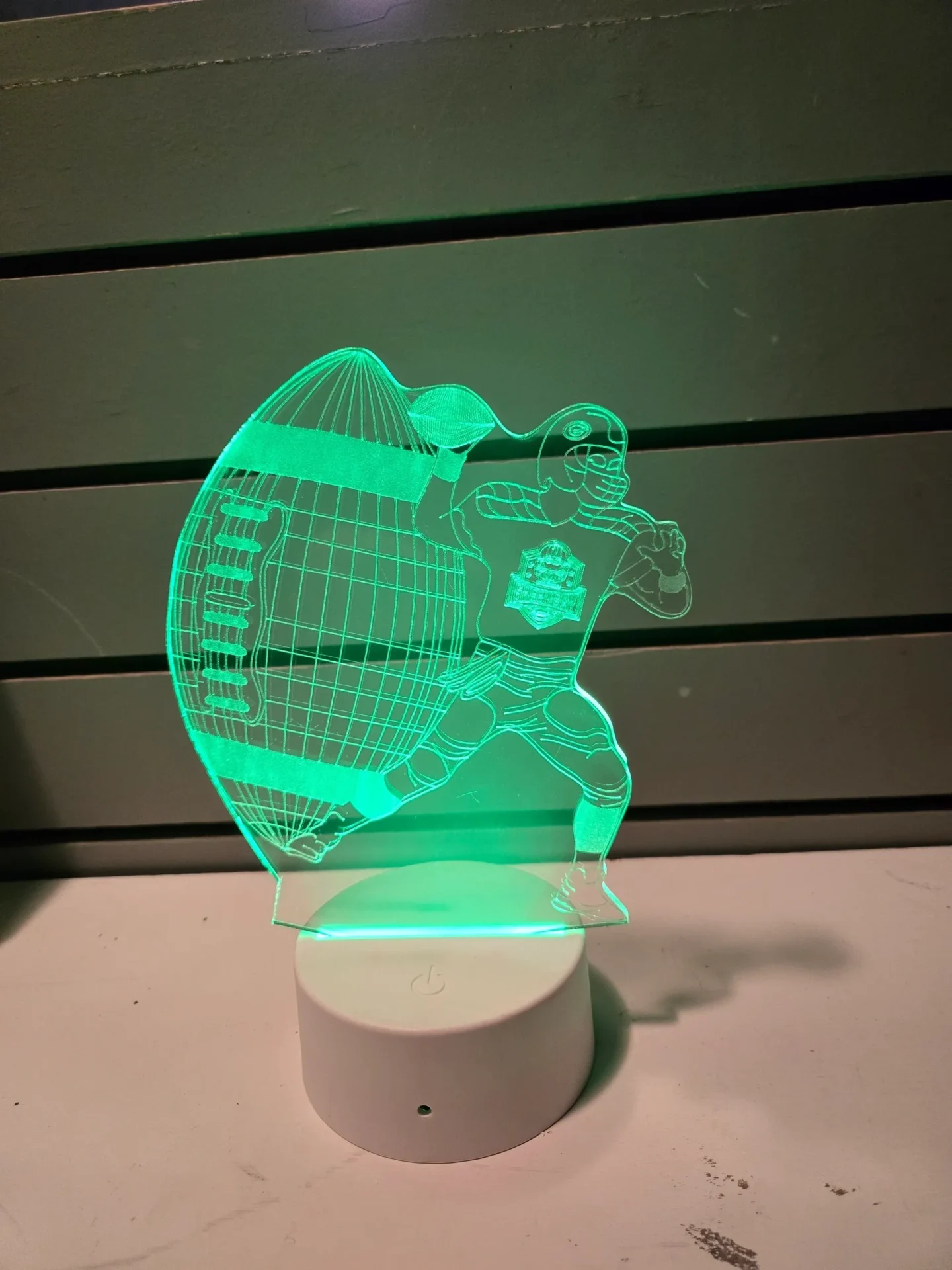 Glowing football player 3D light display.