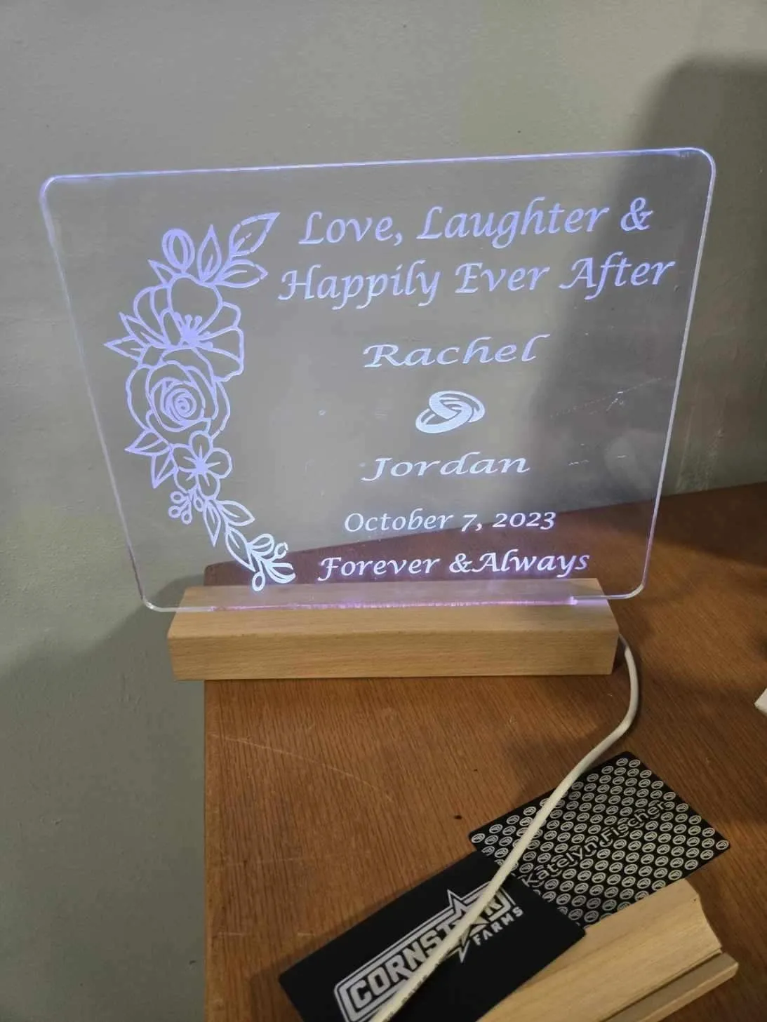 Illuminated engraved glass plaque on stand.