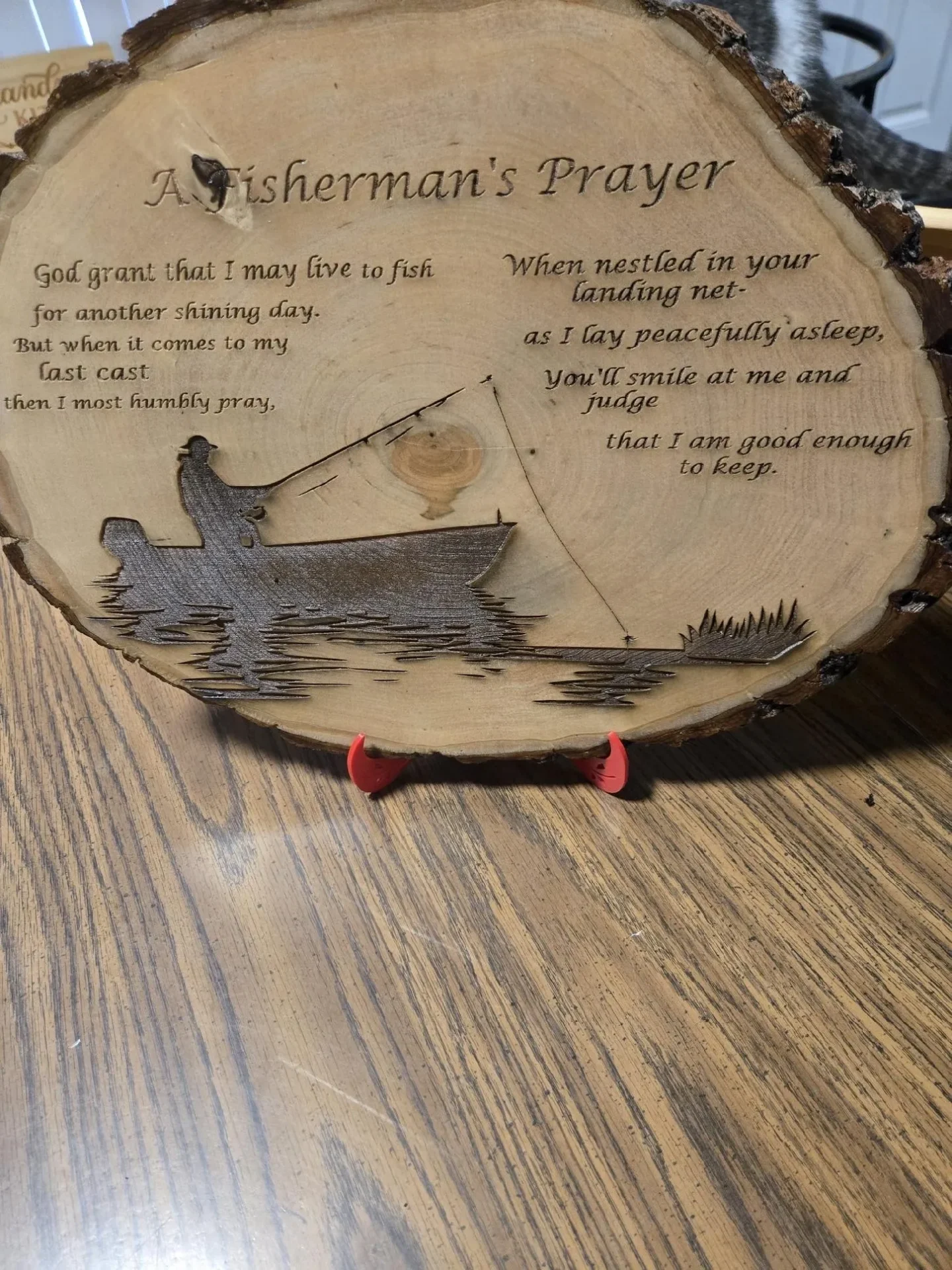Wooden plaque with a fisherman's prayer engraving.