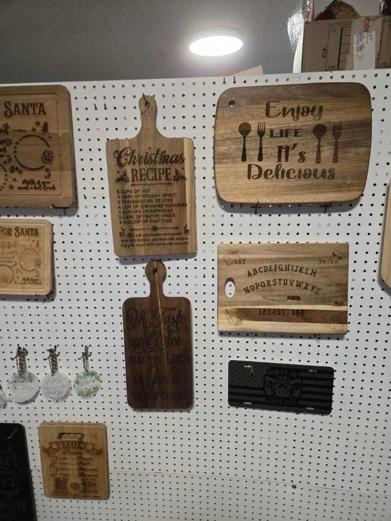 Wooden kitchen decor hanging on pegboard wall.